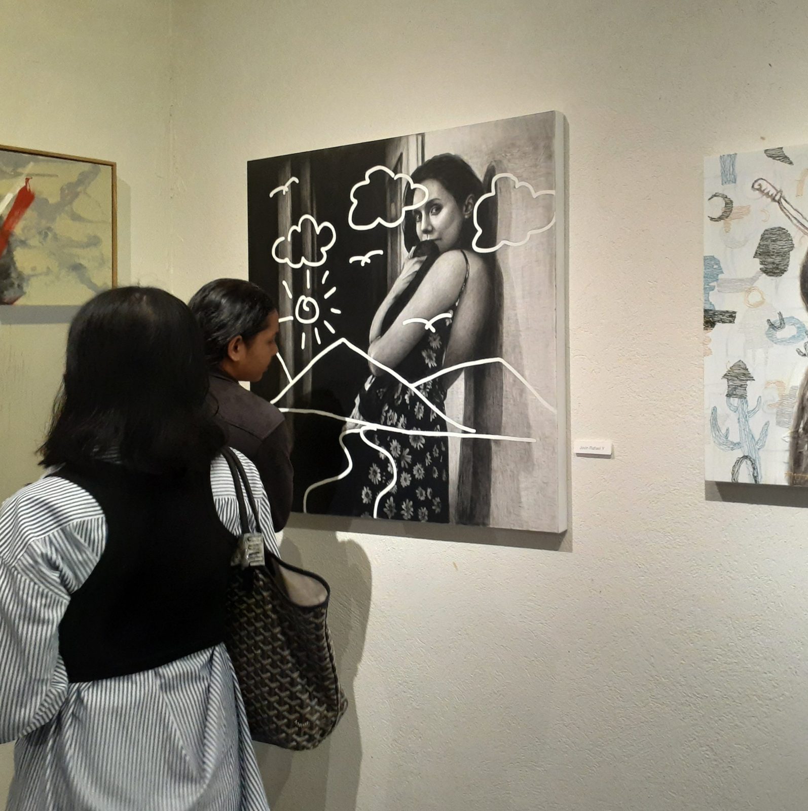 Visitors looking at Connected on a gallery wall at Jogja Affordable Art 2