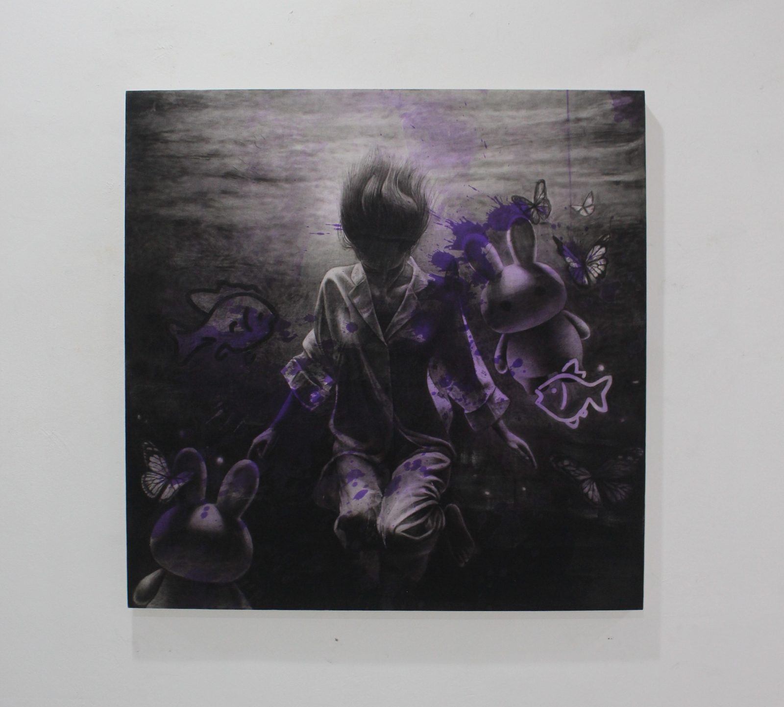 Sunyi, a charcoal and purple painting of a kneeling figure underwater with rabbits, fish and butterflies, hanging on a white gallery wall